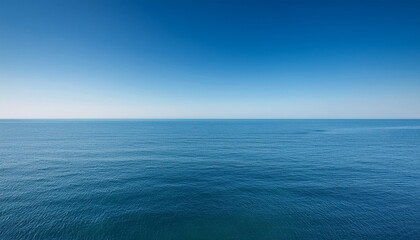 Fototapeta premium Serene Minimalistic Photograph Of Vast Tranquil Ocean Horizon Under Soft Clear Sky Emphasizing Significance Of World