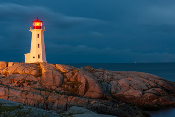 Famous Peggy's Point Lighthouse illuminated at night, Nova Scotia, Canada