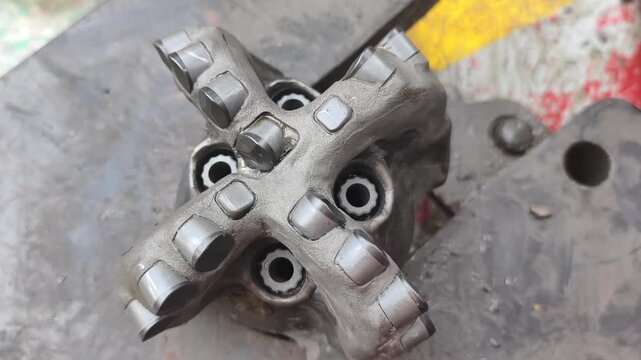 Polycrystalline Diamond Compact (PDC) drilling bit on the rig floor used for drill oil and gas well for petroleum exploration and production.
