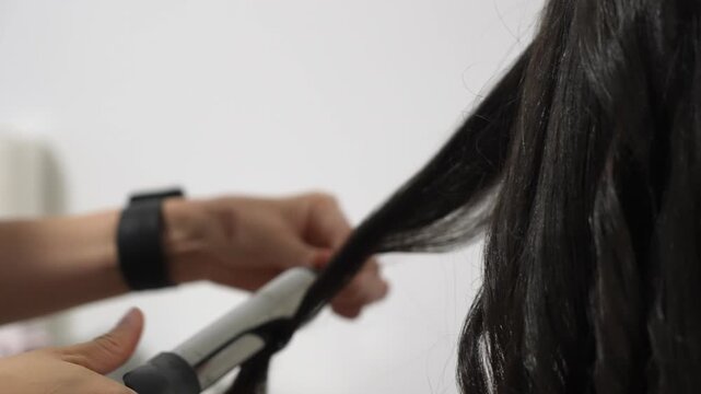 Stylist Curling Long Hair With Curling Iron CloseUp Hands Wrapping Section, Salon Tools Visible, Focused Technique And Finish