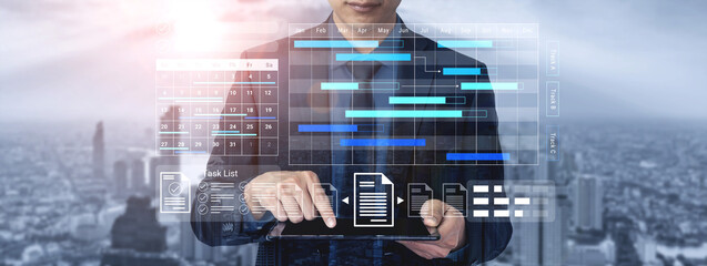 A business professional uses a digital tablet to analyze data trends in a dynamic urban setting, showcasing futuristic technology with graphs and charts for effective decision-making. Gantry