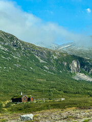 Naklejka premium Traditional norwegian hytte with grass roof in valldal mountains