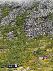 Traditional red and black cabins in norwegian mountain