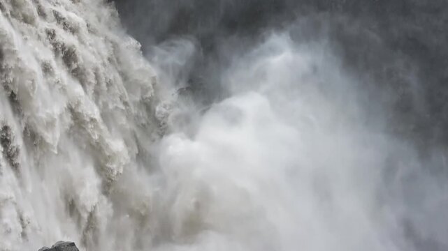 Powerful roaring water flowing at Dettifoss waterfall in Iceland