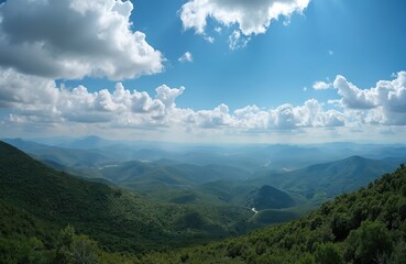 Naklejka premium Expansive vista of rolling green hills under bright blue sky with fluffy white clouds. Winding river snakes through valley, surrounded by rich vegetation. Natural panorama offers sense of peaceful
