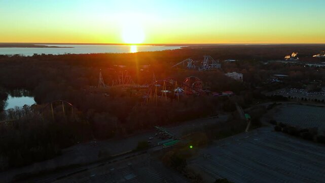 Wide Aerial of Roller Coaster Silhouettes in European Theme Park near James River in Williamsburg, Virginia during Sunset