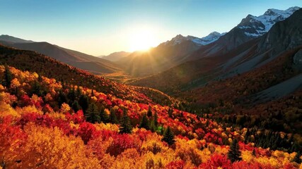 Breathtaking autumn mountain landscape with vibrant red, orange, and yellow foliage under a golden sunset, showcasing nature's beauty.