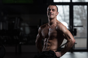 Fototapeta premium Young Bodybuilder Flexing Muscles