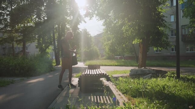 Sunrise Stroll Through Peaceful Neighborhood, Individual Moves Slowly Along Quiet Suburban Pathway At Dawn, Solitary Figure Advances Cautiously On Peaceful Morning Walk Through Suburban Area