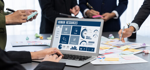 Analyst team use sticky note for creative and analytic brainstorm for business idea with BI data dashboard on laptop screen. Analysis financial data visualization tech for marketing strategy. Prodigy
