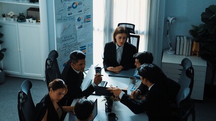 Top view of manager looking at financial statistic chart on tablet at meeting room. Group of business people working together to analyze investment data and planning financial strategy. Directorate.
