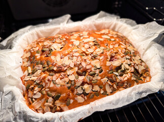 Homemade cake baking with almonds and pumpkin seeds