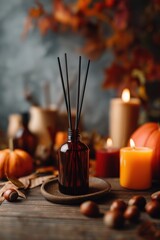 Fototapeta premium Autumn aromatherapy diffuser with candles pumpkins and leaves on wooden table for thanksgiving and fall season decorating ideas