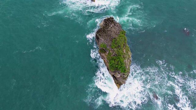Top Down Drone View of Ocean Waves Crashing on Rocky Coast, Ngliyep Beach Indonesia