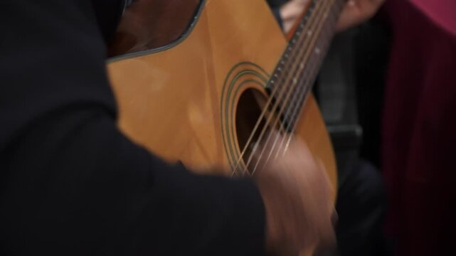 CloseUp Acoustic Guitar Strumming In Intimate Session, Veteran Musician Fingers Moving Over Wooden Fretboard, Warm Timbre And Mellow