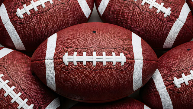 A close-up, high-angle shot features a pile of reddish-brown American footballs, filling the frame. A single football is centered horizontally, dominating the foreground.