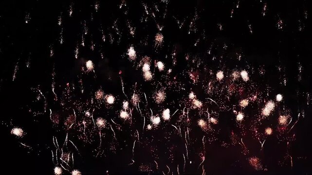 Spectacular white/red fireworks at night. Ideal background for video titles, corporate presentations, product promotions, and grand openers. High-impact visual for success and celebration.