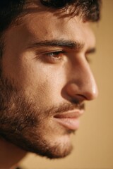 Fototapeta premium Side Portrait of Middle Eastern Man with Glowing Skin in Golden Hour Light 