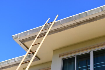 wood ladder for repair house's gutter before rainy season