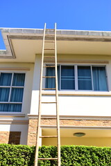 wood ladder for repair house's gutter before rainy season