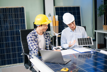 Business people having consultation about wind energy at company office. Business team discussing about windmill and alternative green energy.