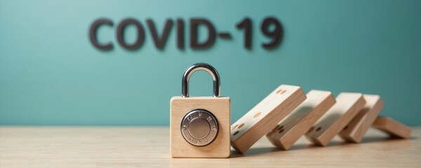 Wooden block padlock stops domino effect. COVID-19 prevention measures halt pandemic spread. Safety and security concept for global health crisis.