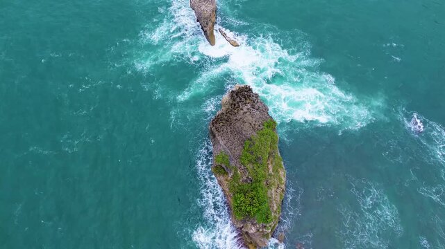Top Down Drone View of Ocean Waves Crashing on Rocky Coast, Ngliyep Beach Indonesia