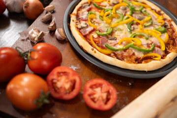 Delectable Pizza Feast: A freshly baked pizza, adorned with vibrant toppings, is artfully presented on a wooden table, surrounded by the essential ingredients that make this culinary delight.