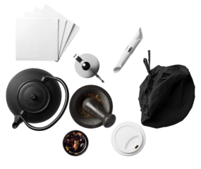 overhead photograph of daily essentials and casual accessories, including a teapot and napkins, set against a stark black backdrop with organized layout