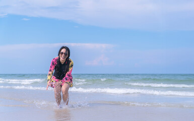 Happy Asian Woman Enjoying Beach Lifestyle in Swimsuit