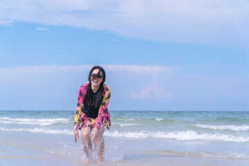 Happy Asian Woman Enjoying Beach Lifestyle in Swimsuit