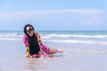 Happy Smiling Woman on Beach Wearing Swimsuit and Sunglasses