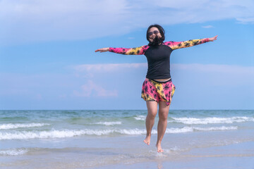 Happy Asain Woman Jumping on Beach in Swimsuit