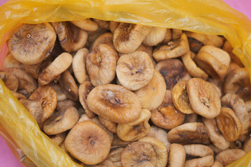 Dried figs in a yellow bag on a table
