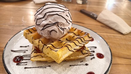 waffles and gelato ice cream served on one plate with a wooden background