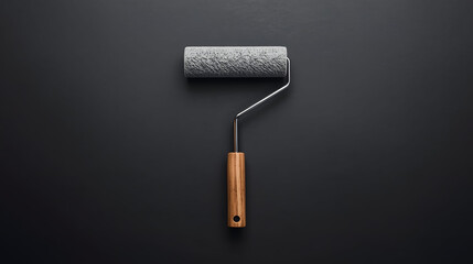 Minimal paint roller on dark textured wall, creative renovation concept with copy space, modern DIY design background and professional home improvement mood