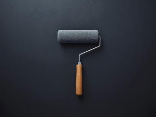 Minimal paint roller on dark textured wall, creative renovation concept with copy space, modern DIY design background and professional home improvement mood