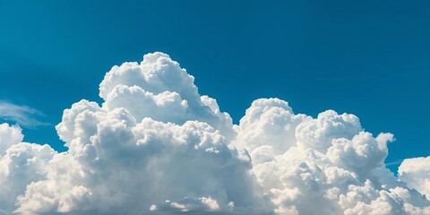 Dense cumulus cloudscape, dramatic lighting, fluffy white clouds against deep blue sky,  cloud cover,  sky