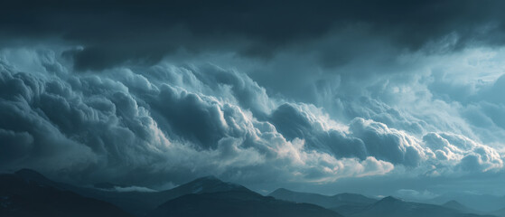 Dramatic storm clouds form heavy grey layers over a moody northern landscape