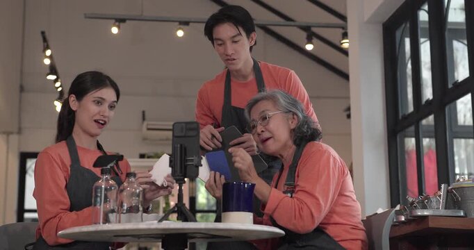 A mother, son, and daughter from a family business host a live stream, showcasing ceramic products on camera while managing orders and engagement for e commerce sales.
