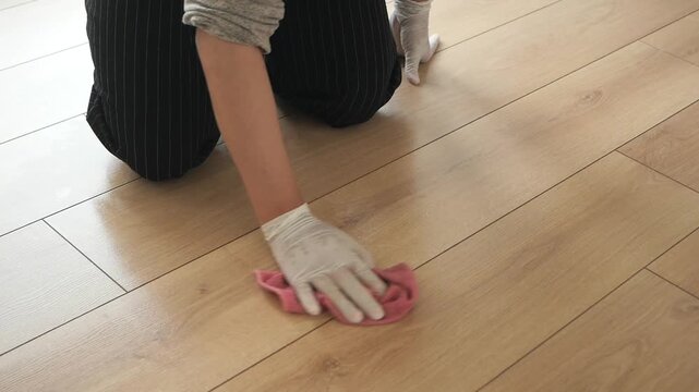 Cleaning wooden floor with a child helper in the home