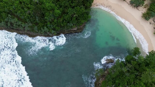 Top Down Drone View of Ocean Waves Crashing on Rocky Coast, Ngliyep Beach Indonesia