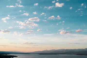 Fototapeta premium Azure Horizons: Serene Sky, Clouds, and Mountain Lake View