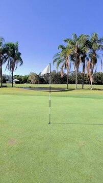 Sunny Golf Green Flag Close-Up on Gold Coast Course