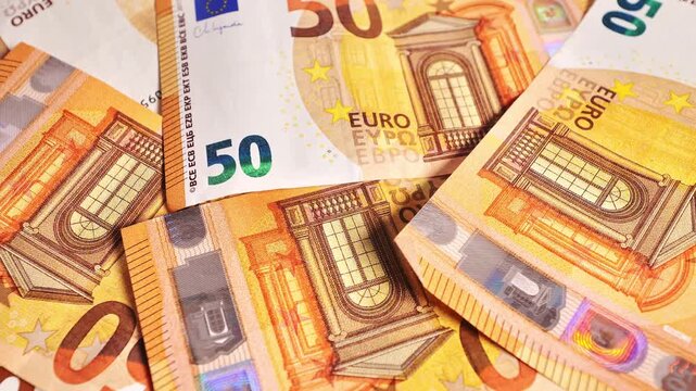 Bright fifty euro notes spinning on platform in clean studio setup for business