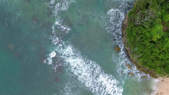 Top Down Drone View of Ocean Waves Crashing on Rocky Coast, Ngliyep Beach Indonesia