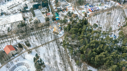 empty amusement park with various attractions at winter sunny day. aerial view.