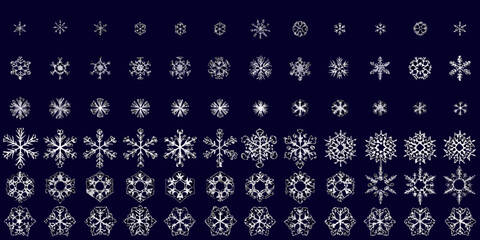 Intricate collection of diverse snowflake designs against a dark blue backdrop