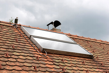 Solar water heater system on roof top showcasing sustainable energy, eco-friendly technology for home or building.