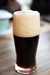 Draft dark beer in glass on table